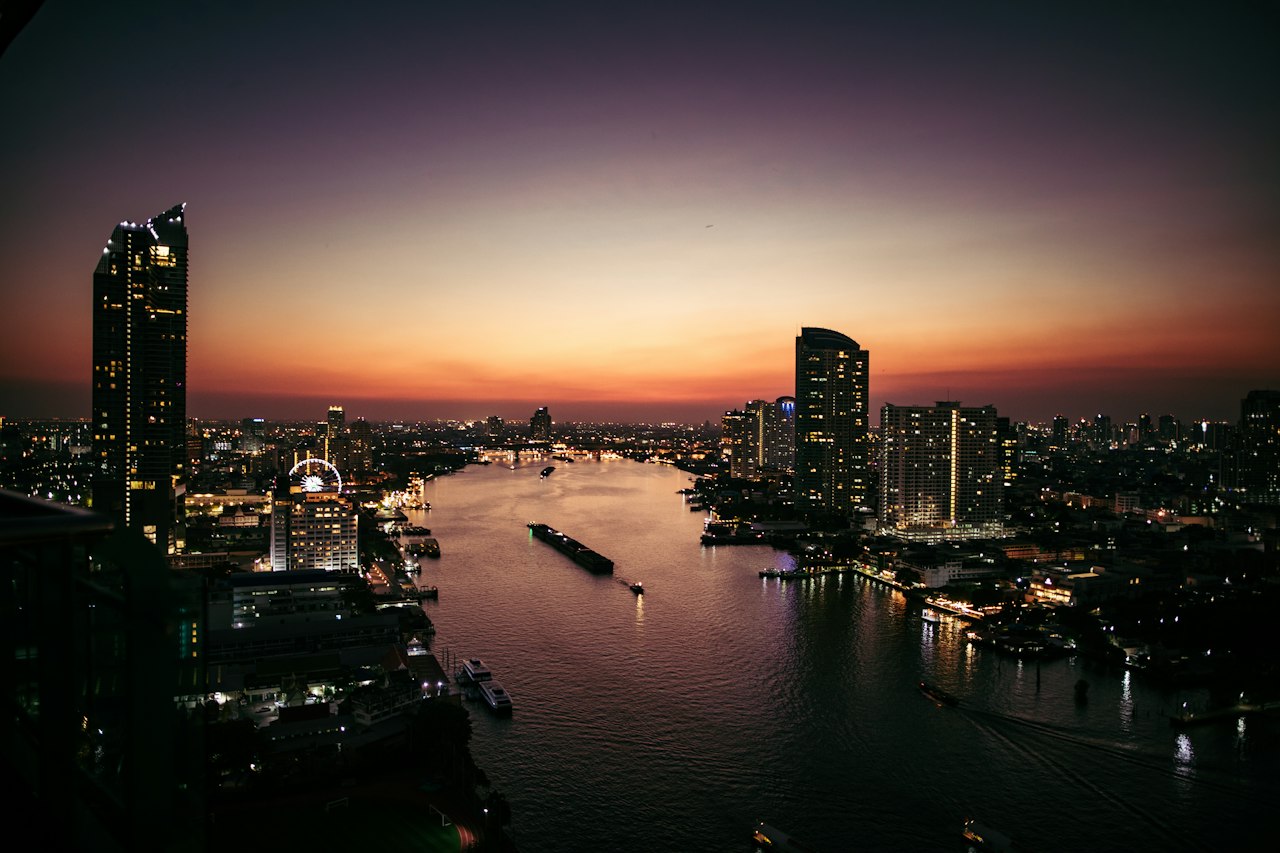 The Chao Phraya River winding through Bangkok at dusk