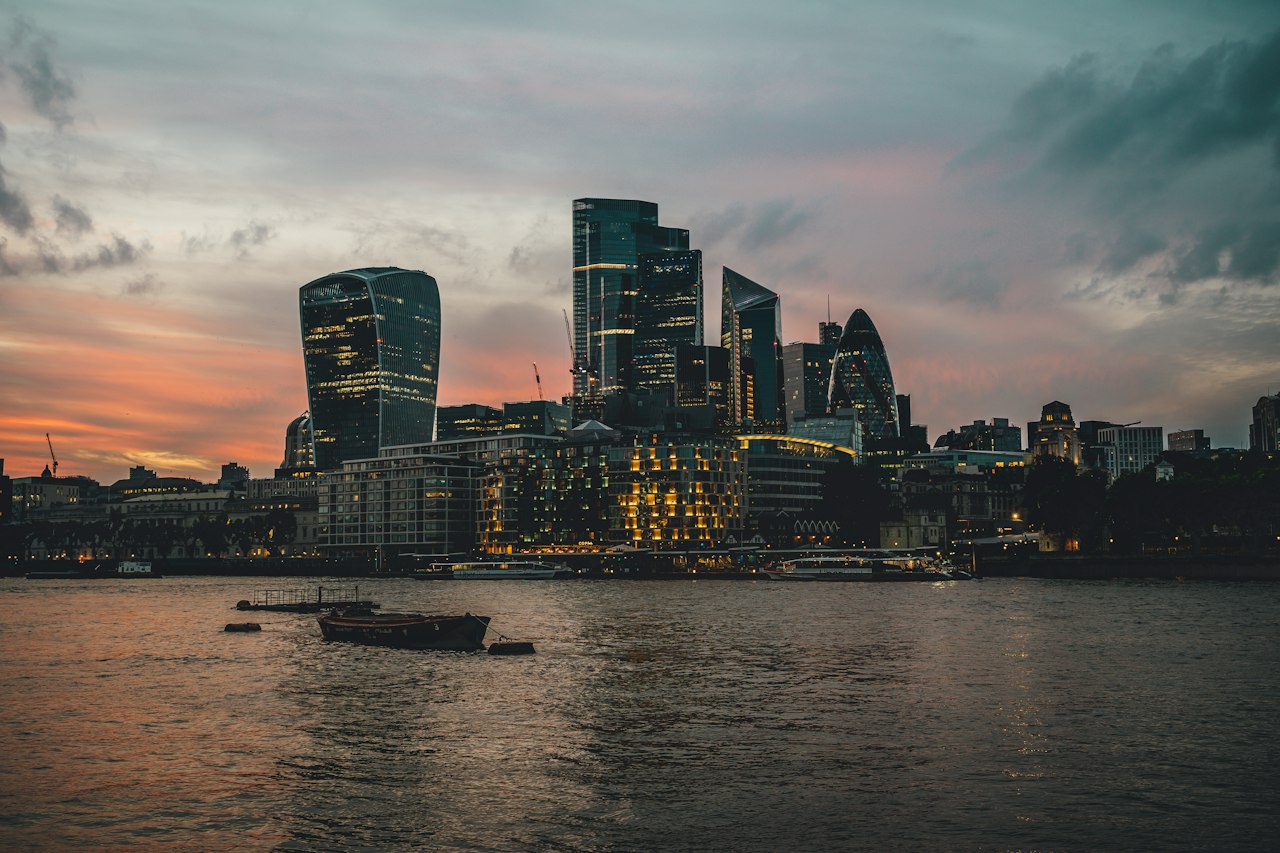 The City of London's towers across the Thames at sunset