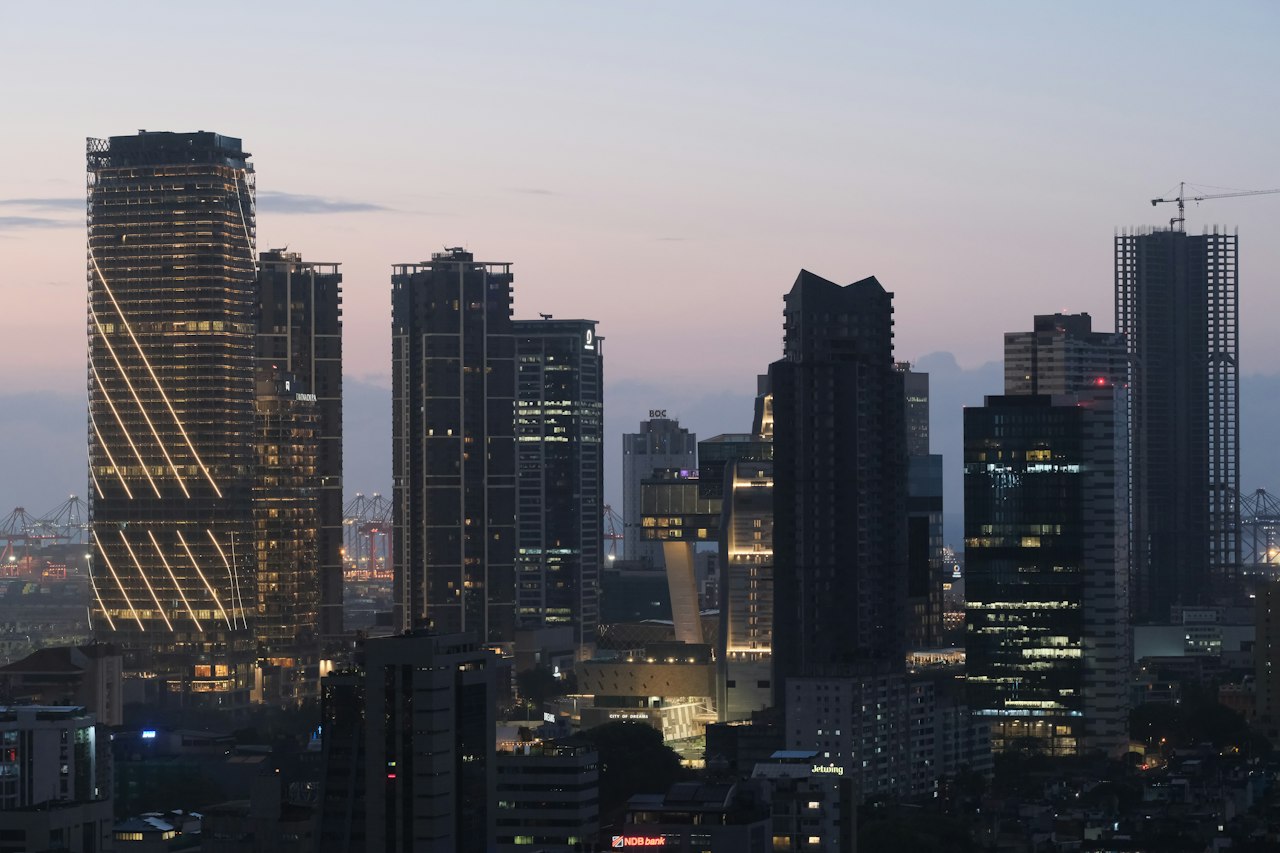 Colombo's towers lit against a soft dusk sky