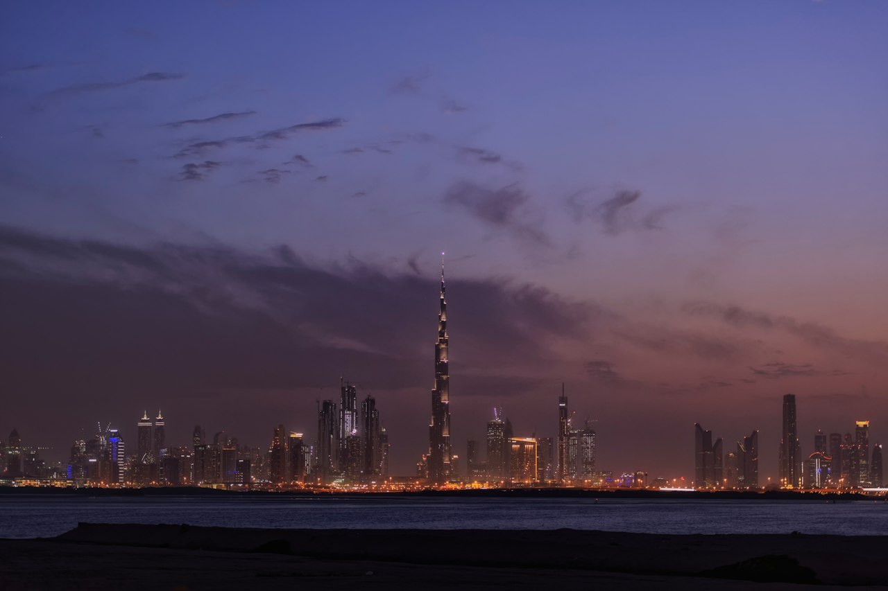 The Dubai skyline and Burj Khalifa across the water at dusk
