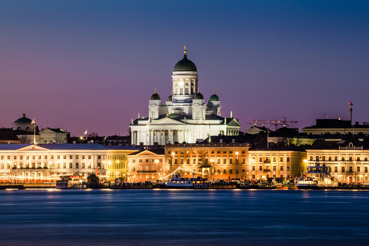 Helsinki Cathedral above the lit South Harbour waterfront at dusk