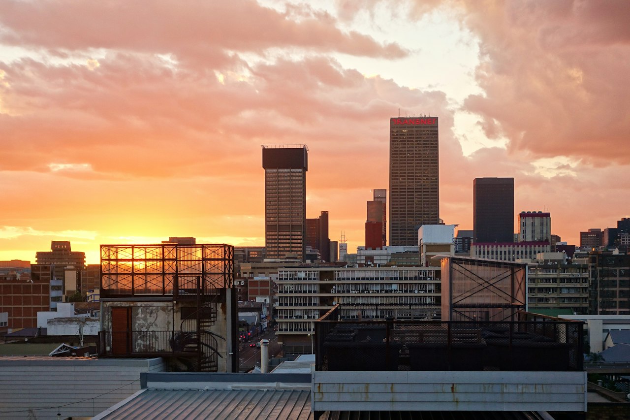 Johannesburg's city-centre towers beneath a glowing sky at dawn