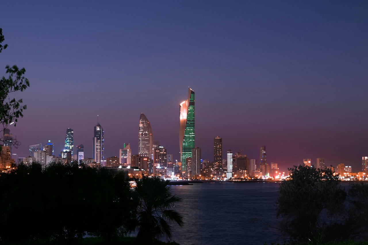 The Kuwait City skyline across the bay at dusk