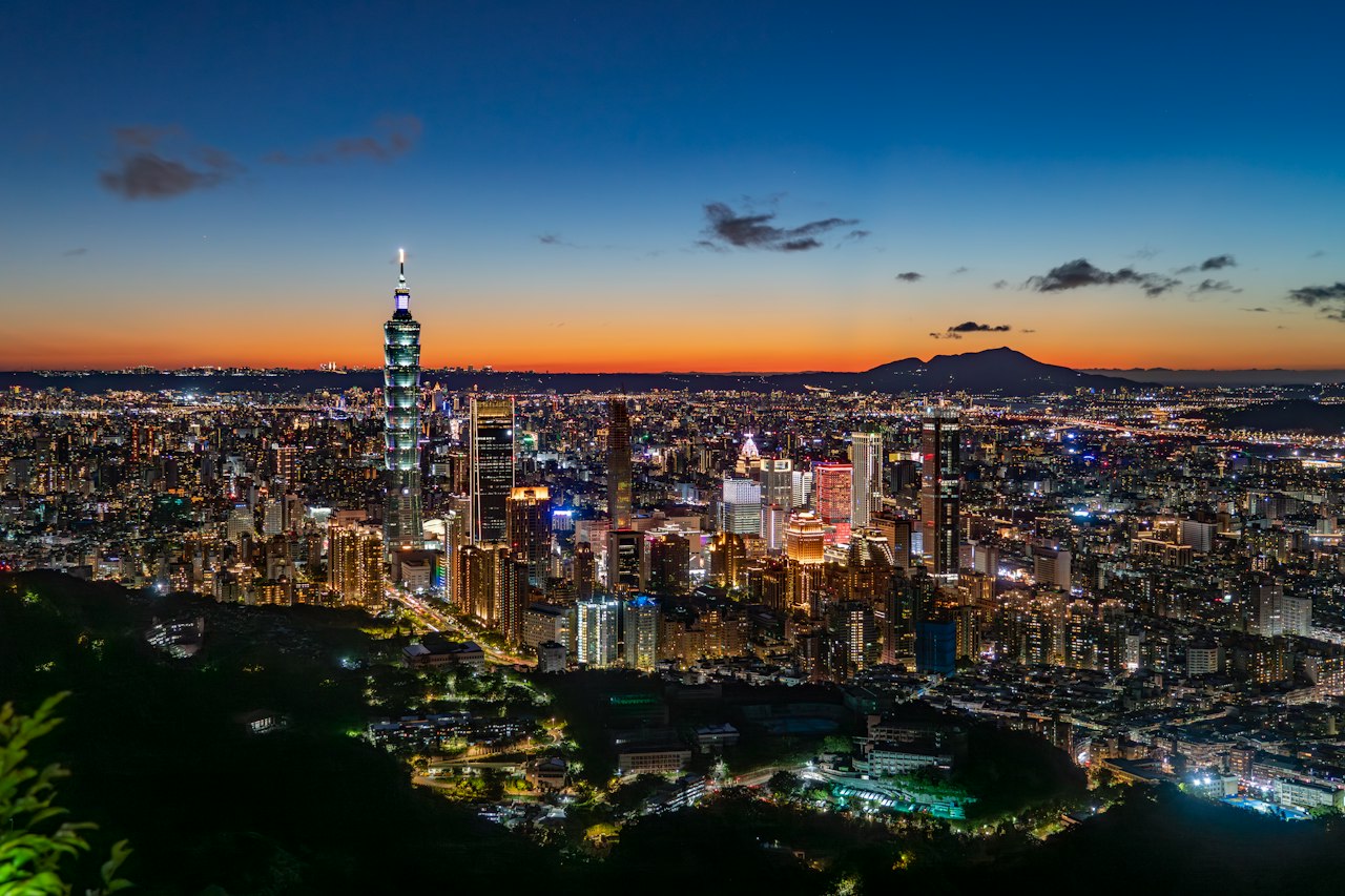 Taipei 101 and the Taipei skyline at blue hour from a hillside