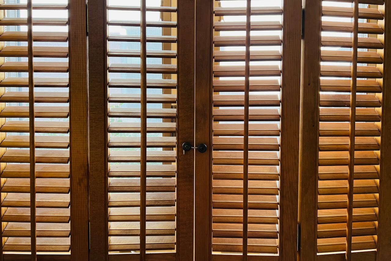 Wooden shutters filtering soft light into a room